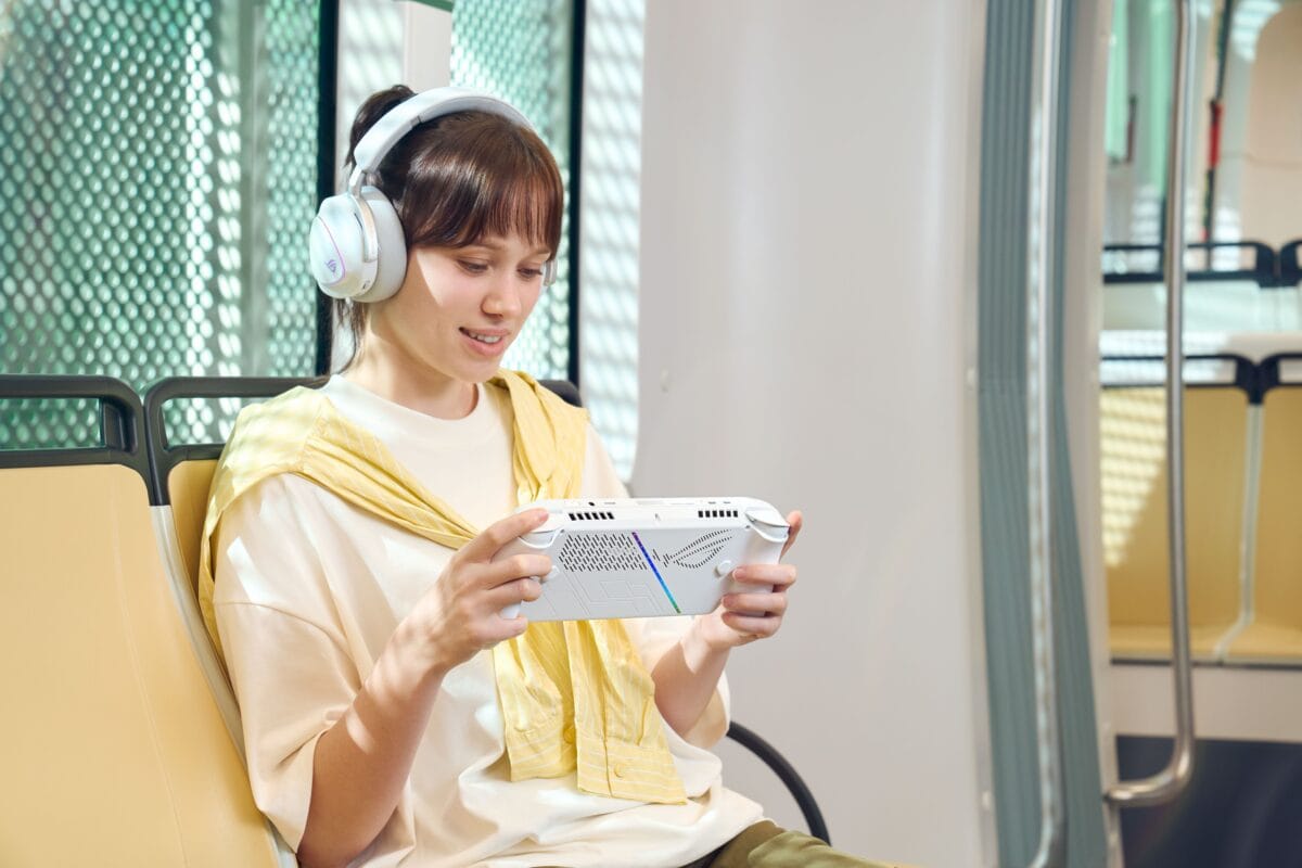 ROG Xbox Ally handheld used during commute with wireless headphones